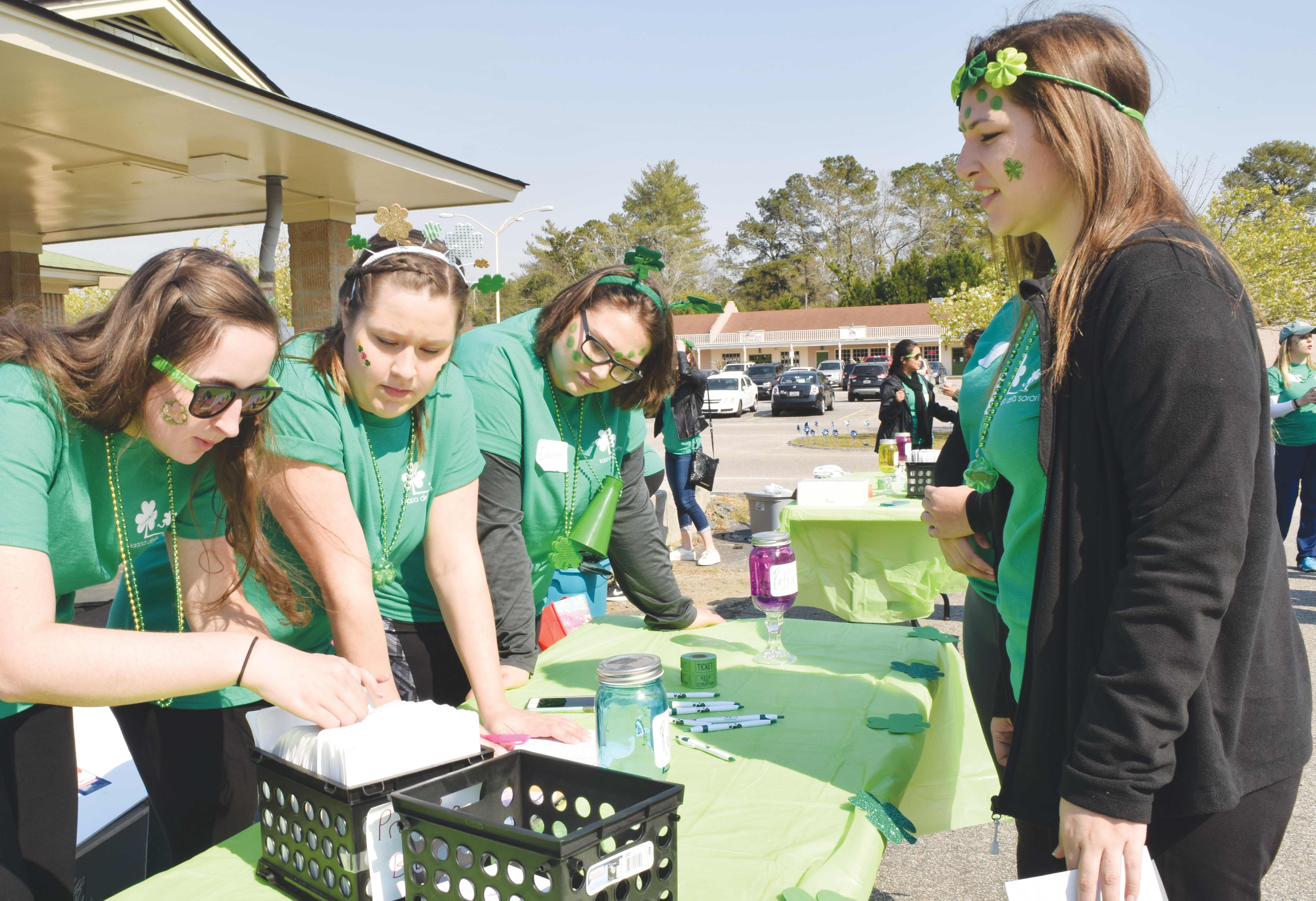 KD members work at the registration booth during the March 4 5K. Proceeds were donated to the Durant Children’s Center and National Prevent Child Abuse America.