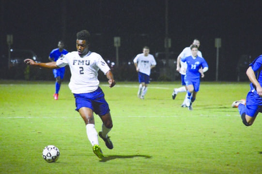  Gael Mabiala (2) kicks the ball up the field towards the goal with the help of fellow Patriots behind him.