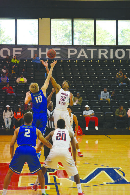 Sophomore Judah Alexander (22) jumps for the ball in the tipoff
against the Georgia College Bobcats. The 91-74 win brings the
men’s team to a 12-8 overall record.