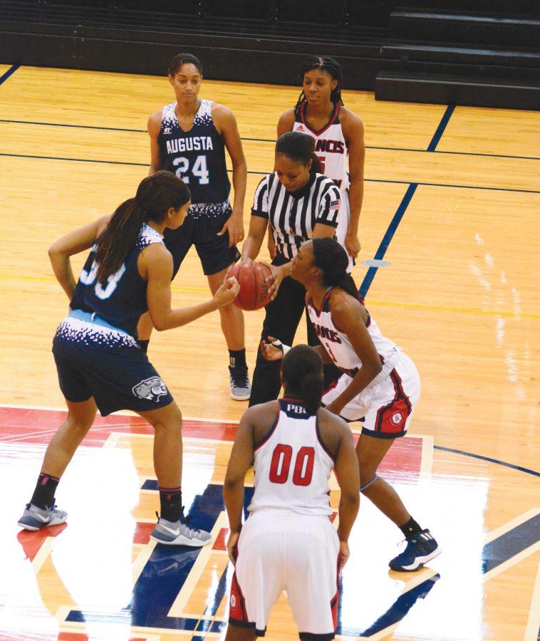 FMU forward Briana Burgins faces Flagler forward Tiffany Hodge for the tip-off. Burgins helped lead FMU to victory with 13 points.
