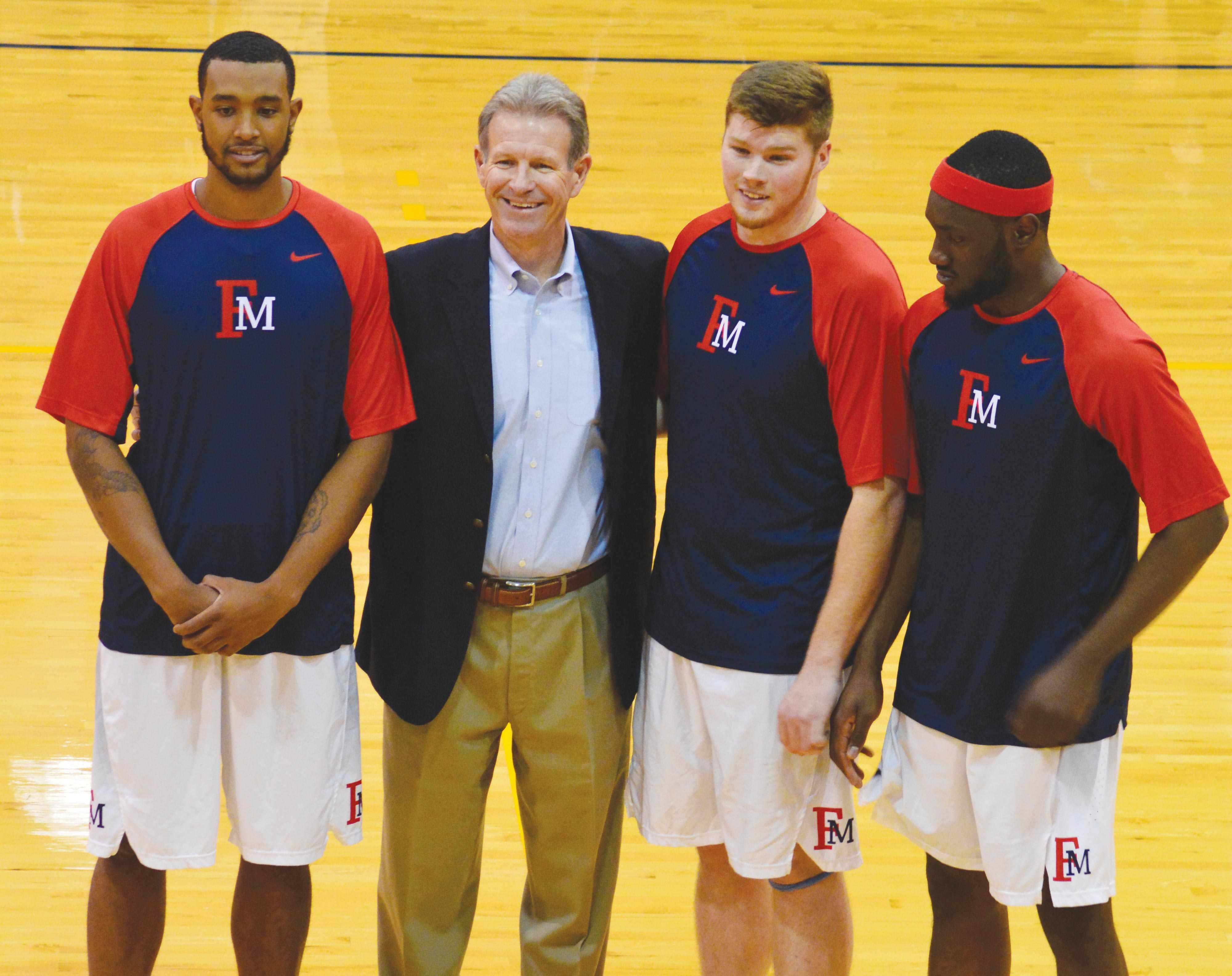 Head coach, Gary Edwards, poses with seniors Nigel Holley (42), Kenneth Jackson (40) and Samson Nnaji (5) before the last home game of the season.