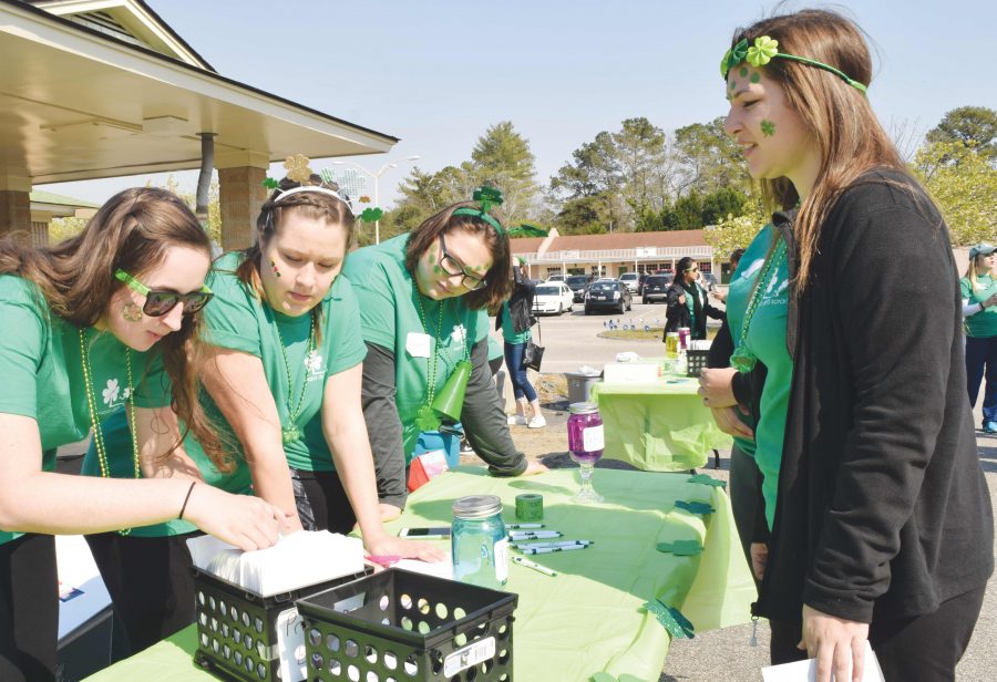 KD members work at the registration booth during the March 4 5K. Proceeds were donated to the Durant Children’s Center and National Prevent Child Abuse America.