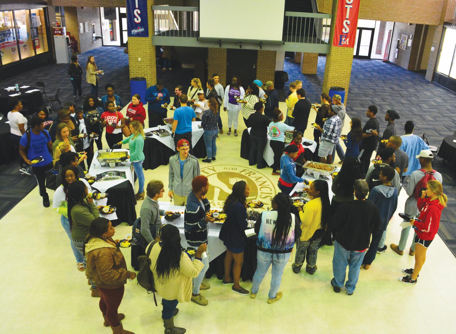 Students taste foods from around the world such as vegetable biryani from India during the Cultural Food Fest.