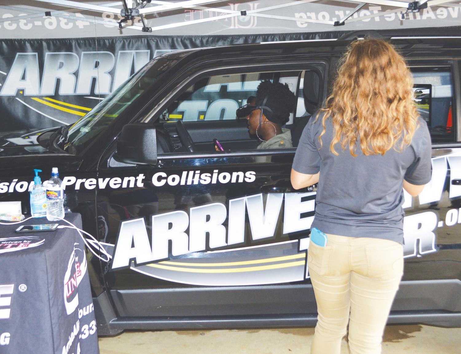 An FMU student participates in the distracted driving simulation during the Oct. 23 event.