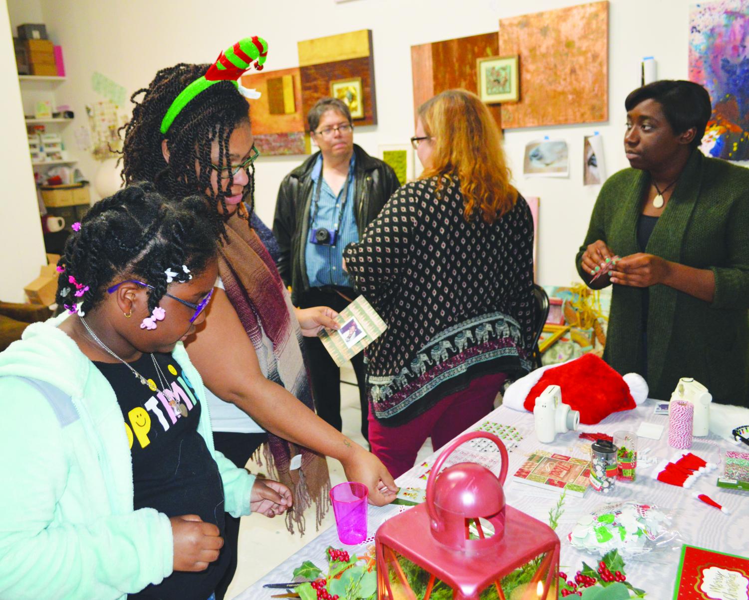 FMU Students take part in creating ornaments from Polaroids at TthomasArts, a local art studio, during the Nov. 9 workshops.