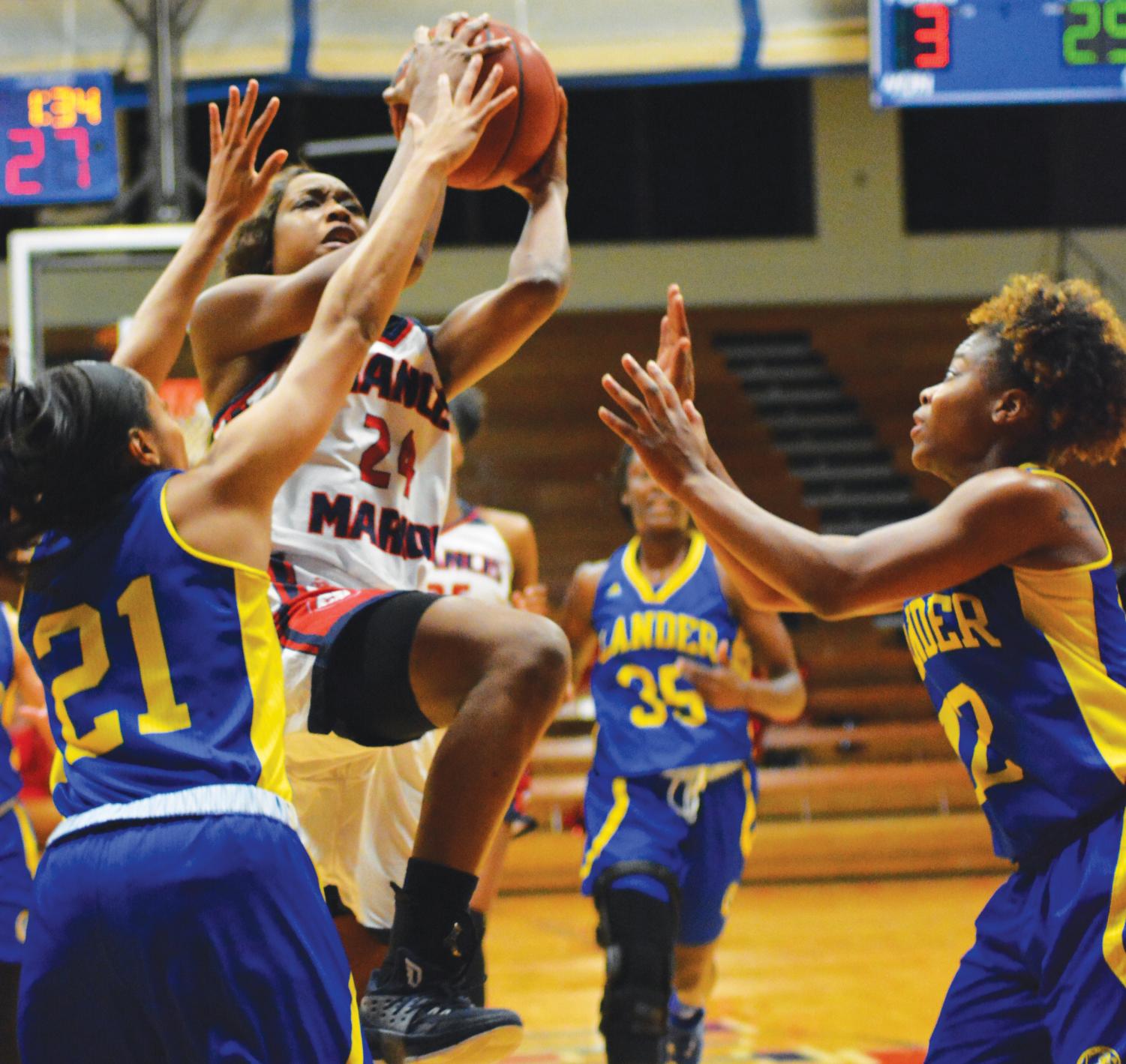 Junior Shaunice Fulmore (24) lays up the ball against the Lander Bearcats. During this game, Fulmore scored 15 points.