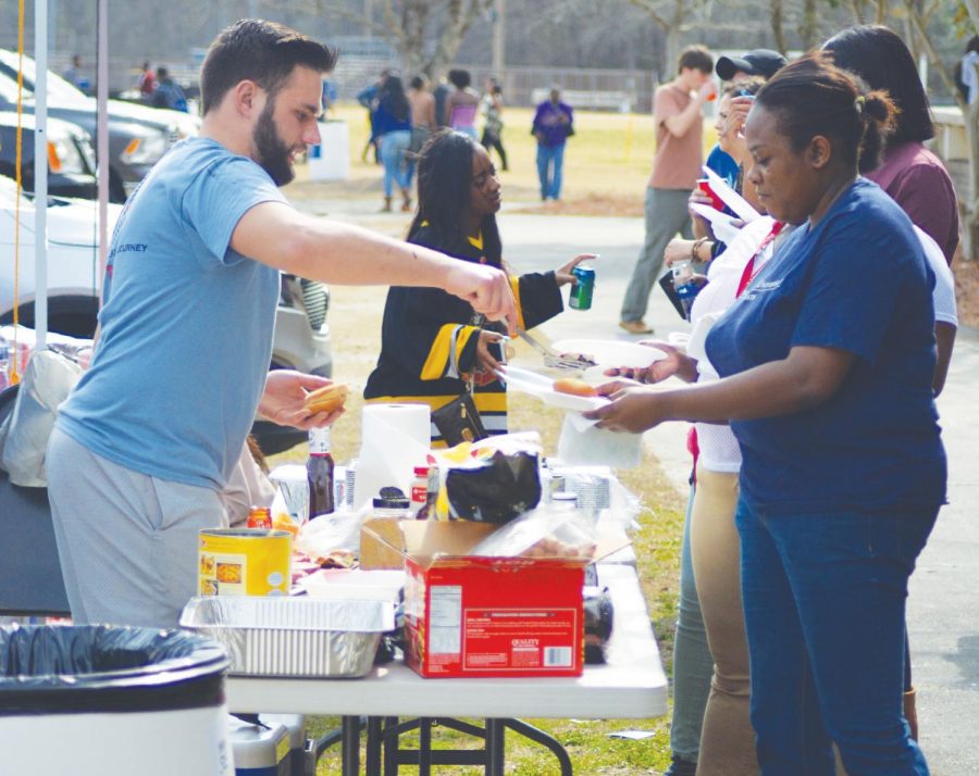 FMU faculty, students and alumni assemble tents and make food during the Homecoming tailgate. Tailgating took place from 11 a.m. throughout the basketball games. 