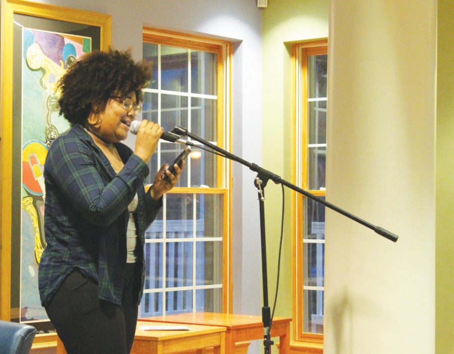 Mary Fountain reads a piece of her original poetry during the Snow Island Review poetry slam. 