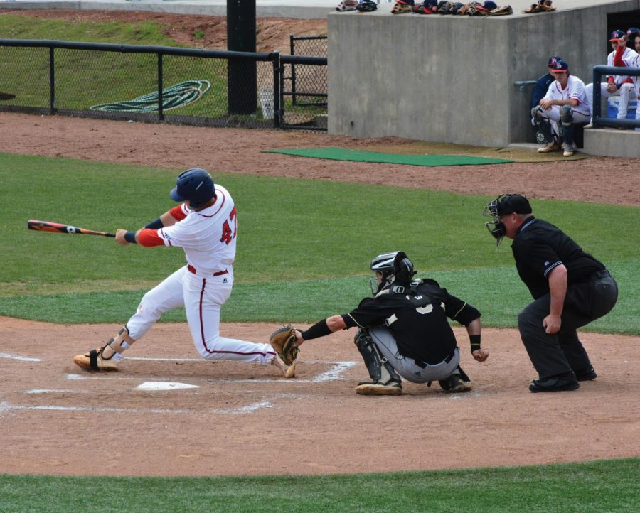 Trey Chapman, senior, scores a run against UNC Pembroke to help the Patriots win one game in Sunday’s double header.