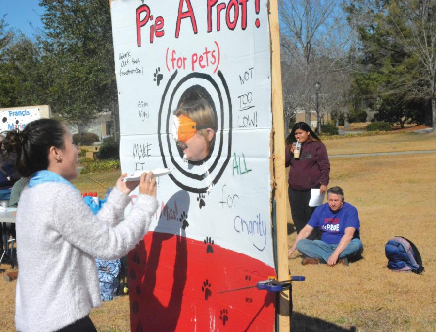 Student Elizabeth Floyd throws a pie at a professor to help raise money and awareness for the Marion county Humane Society.