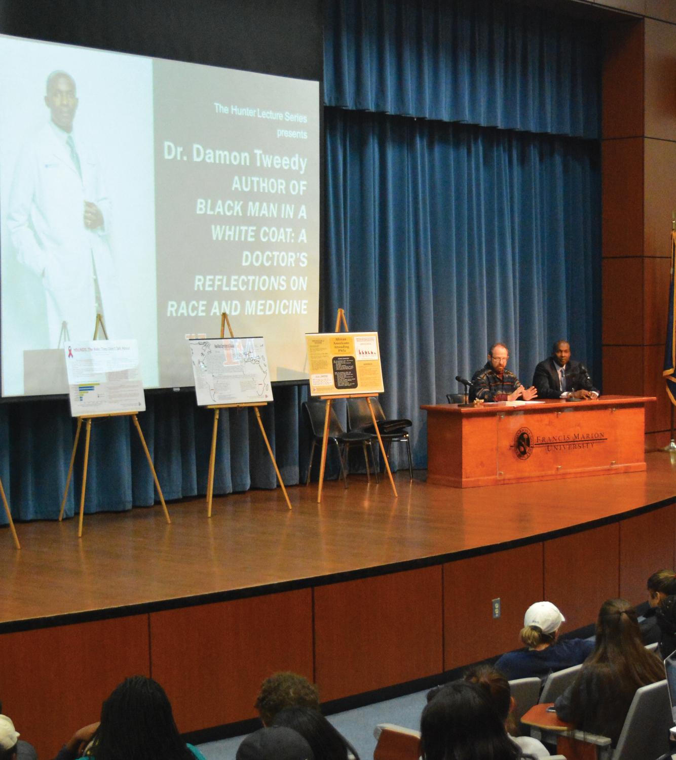 Smolen-Morten interviews Dr. Damon Tweedy about his book. Dr. Damon Tweedy invites students to ask questions about race relations and his life’s work. Tweedy’s book was the common text for English 102 this semester.