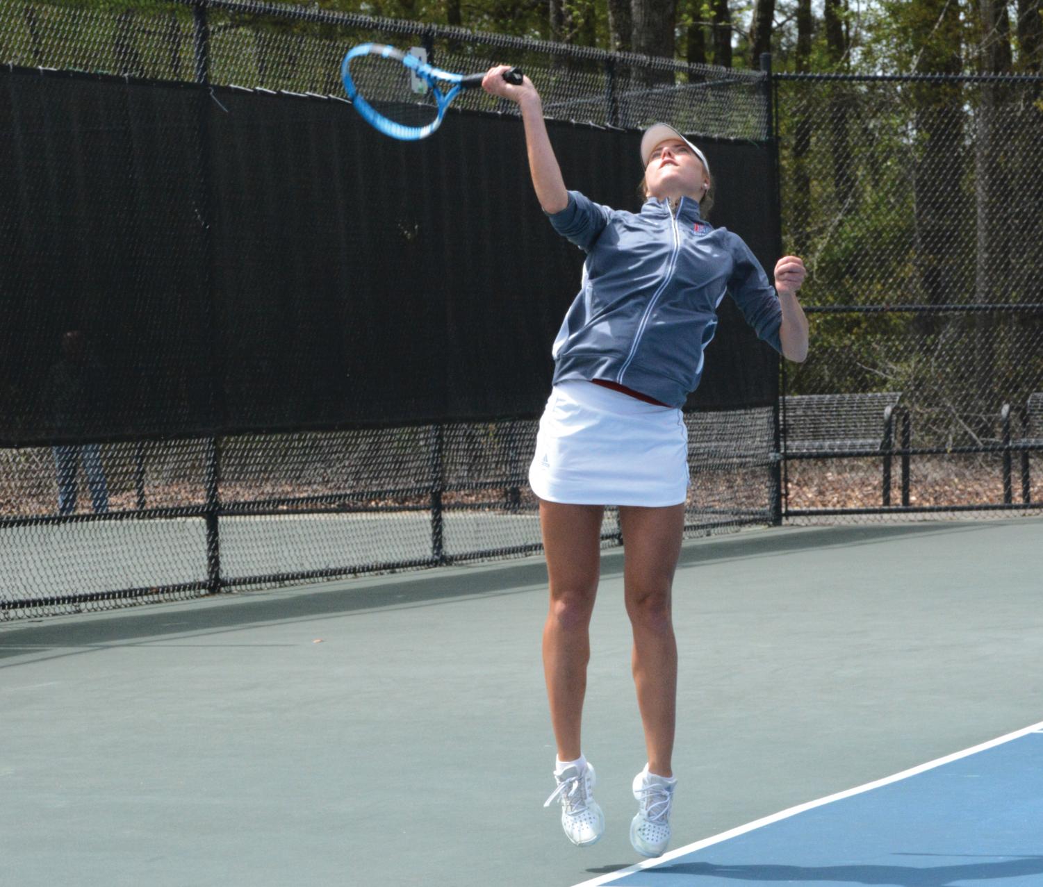 Senior Sofia Henning serves the tennis match during her last singles match as a lady Patriot.