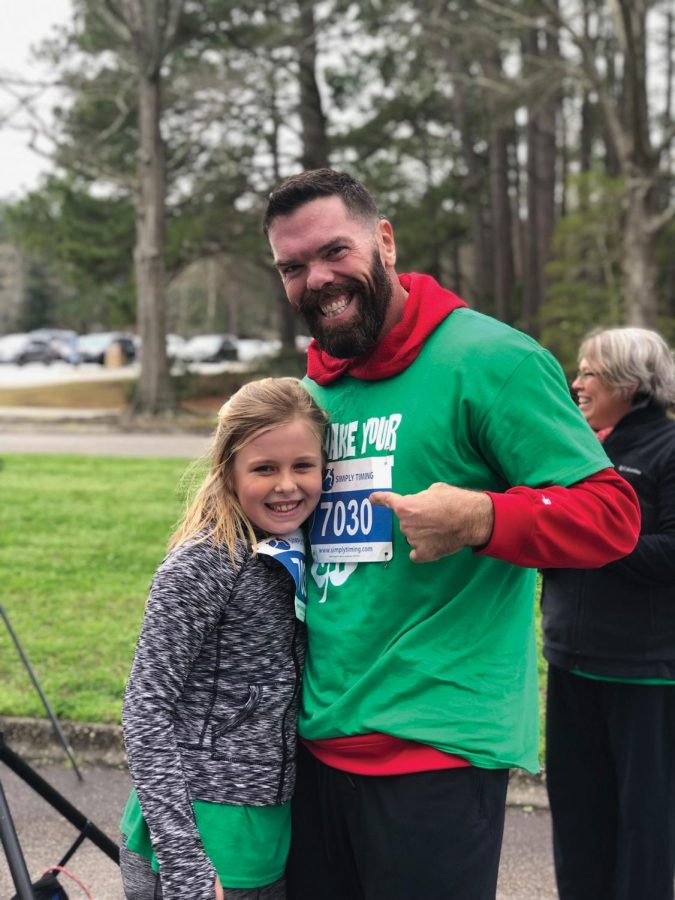 Brian Edwards, one of the winners of the 5K, poses with his daughter, Vivian Edwards. 