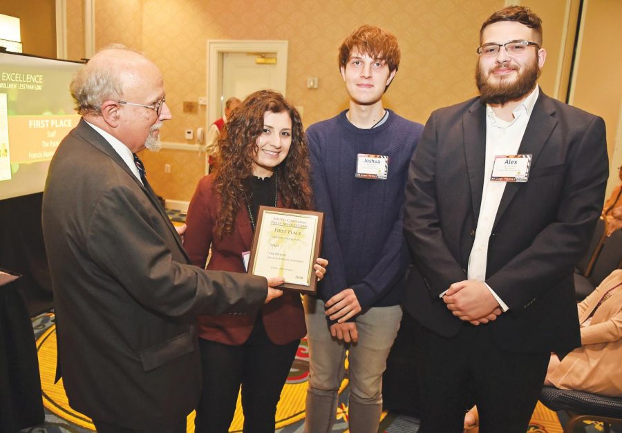 Editor-in-Chief Kaitlyn Luna, Managing Editor Alex Turbeville and Assistant Editor Joshua Hardee accept the award for first place for general excellence. 
