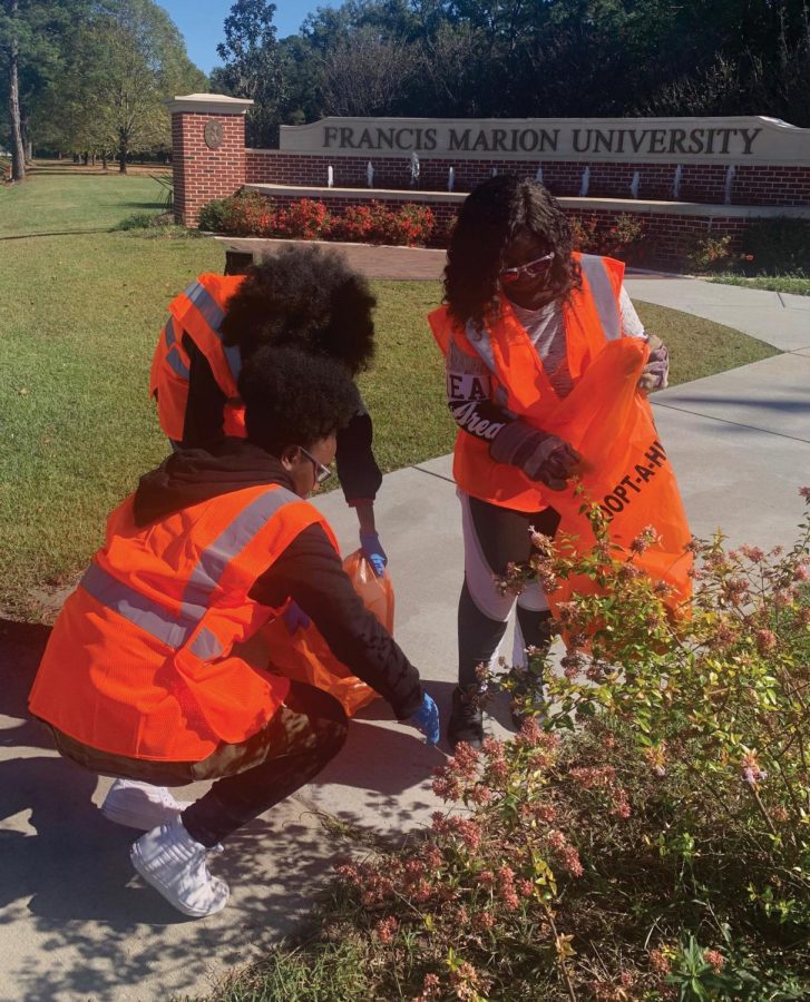 Members of the Green Club pick up trash along the two-mile stretch of highway in front of FMU. 