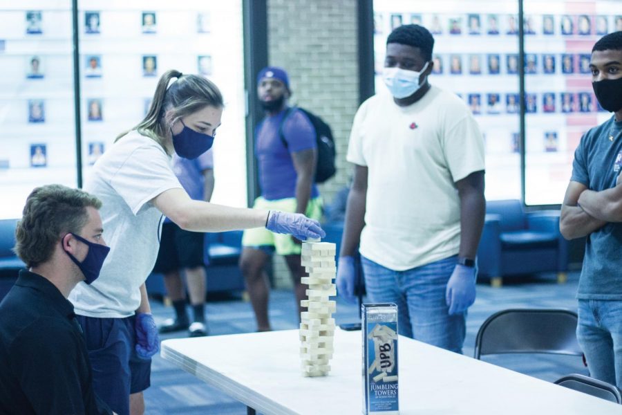 Students challenge each other in a friendly game of Jenga. 
