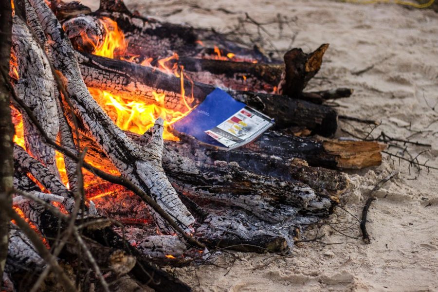 Students burn journals, calendars and other mementos from 2020 in a bonfire outside the UC.