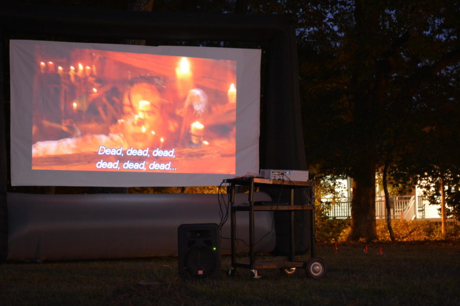 An inflatable projector shows Hocus Pocus for honors students on the Founders Hall lawn. 
