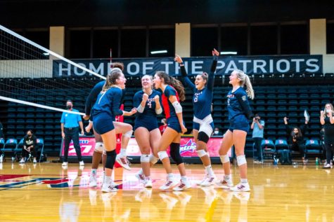 The Lady Patriots celebrate a point against UNCP.
