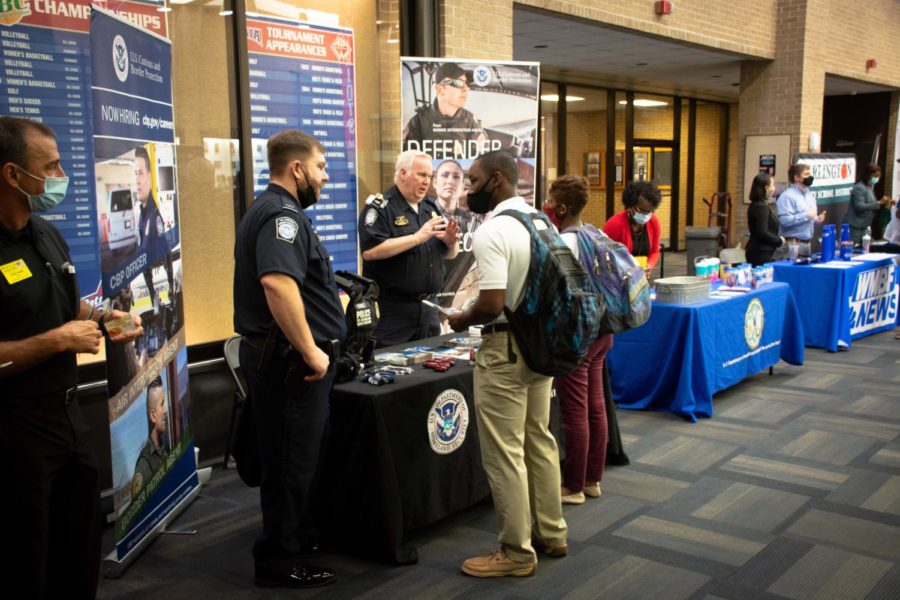 An FMU students talks to the law enforcement booth.