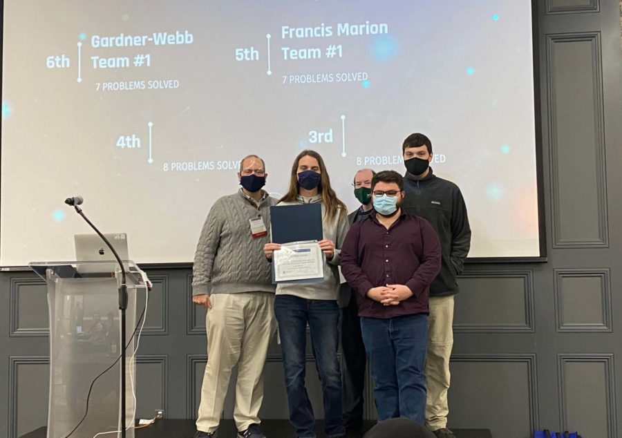 FMU's computer science team accepts the fifth-place award at CCSC programming competition.