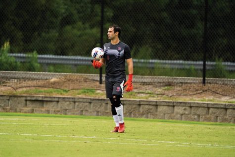 MBA student and goalie for the Patriot men’s soccer team Adrea Scapolo looks for a teammate to take the ball up the field.