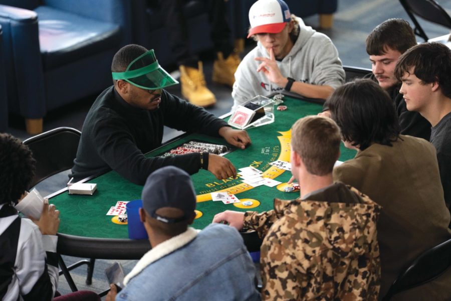 Students gather at a Blackjack table with their gifted token and compete for winning.