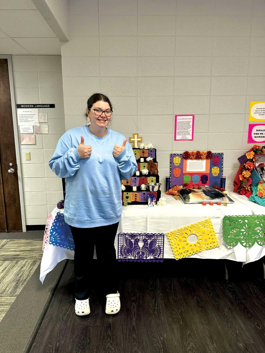 Senior double major Taylor Tanner stands with her winning altar.