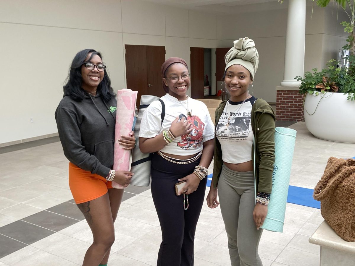 (From left to right) Smiyah Pinckney, Tykeria Blakely and Omiya Baccus relax with yoga.