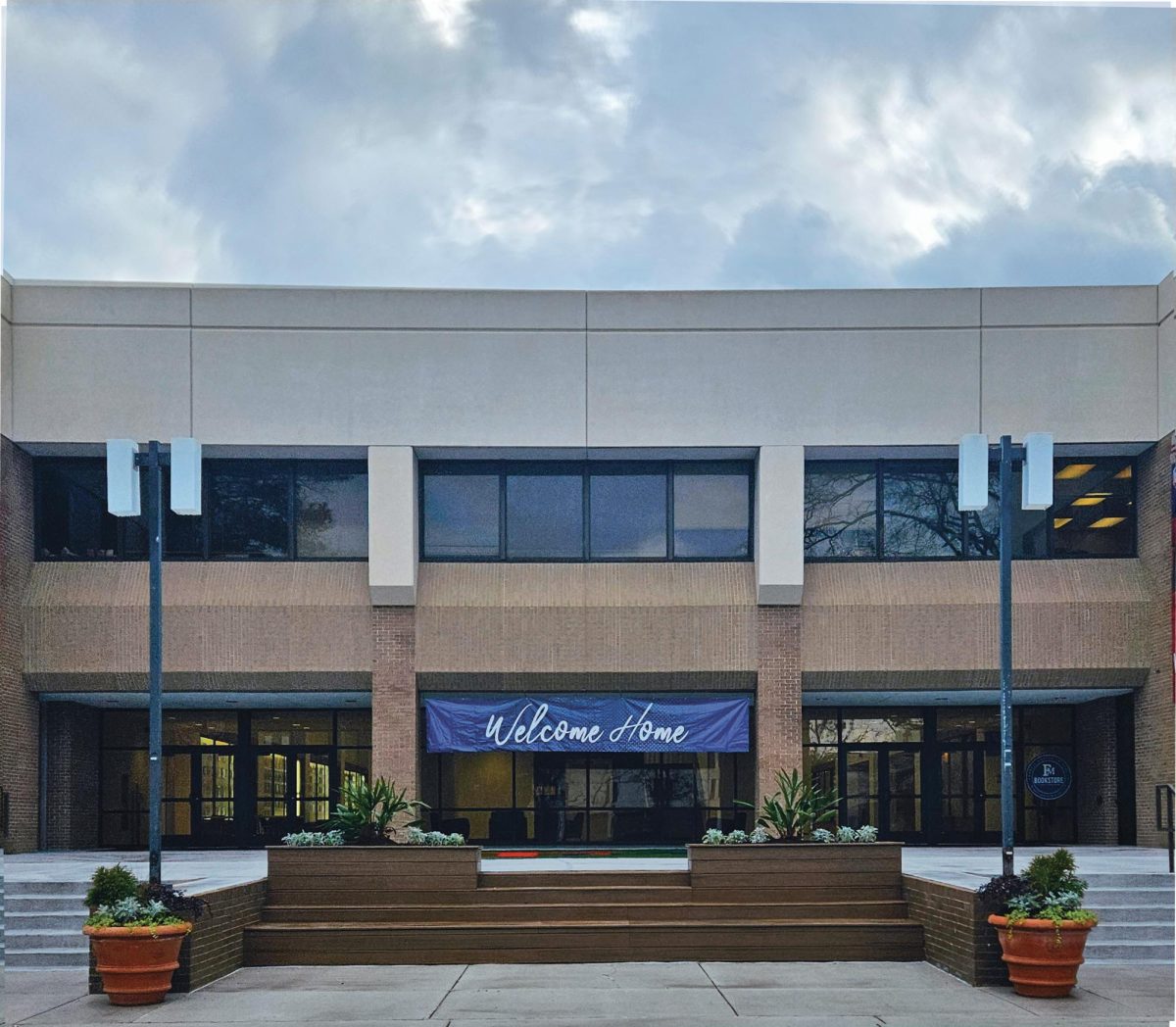 The newly renovated Smith University Center features new entrance with steps and grass patch.