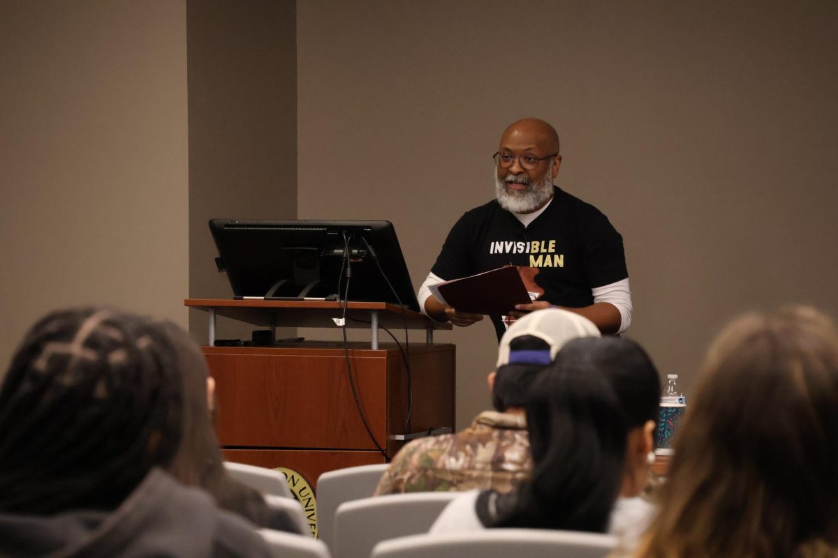 Author Gary Jackson reads one of his new poems, "Fourth of July," from his new book "Small Lives: Poems," at Harris Auditorium (April 9, 2026). 